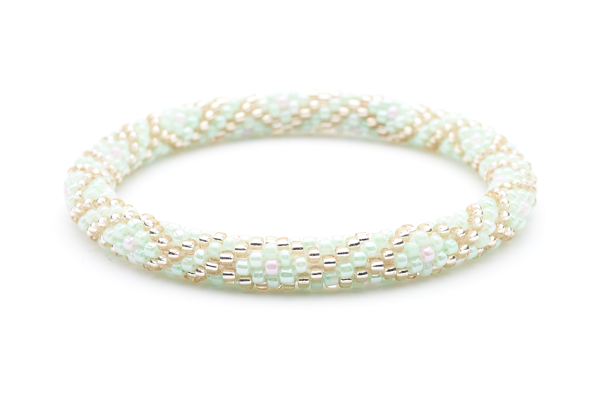 Sashka Co handmade beaded friendship bracelet with mint, rose gold, and pink criss cross pattern. Crafted in Nepal by skilled artisans.
