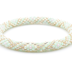 Sashka Co handmade beaded friendship bracelet with mint, rose gold, and pink criss cross pattern. Crafted in Nepal by skilled artisans.