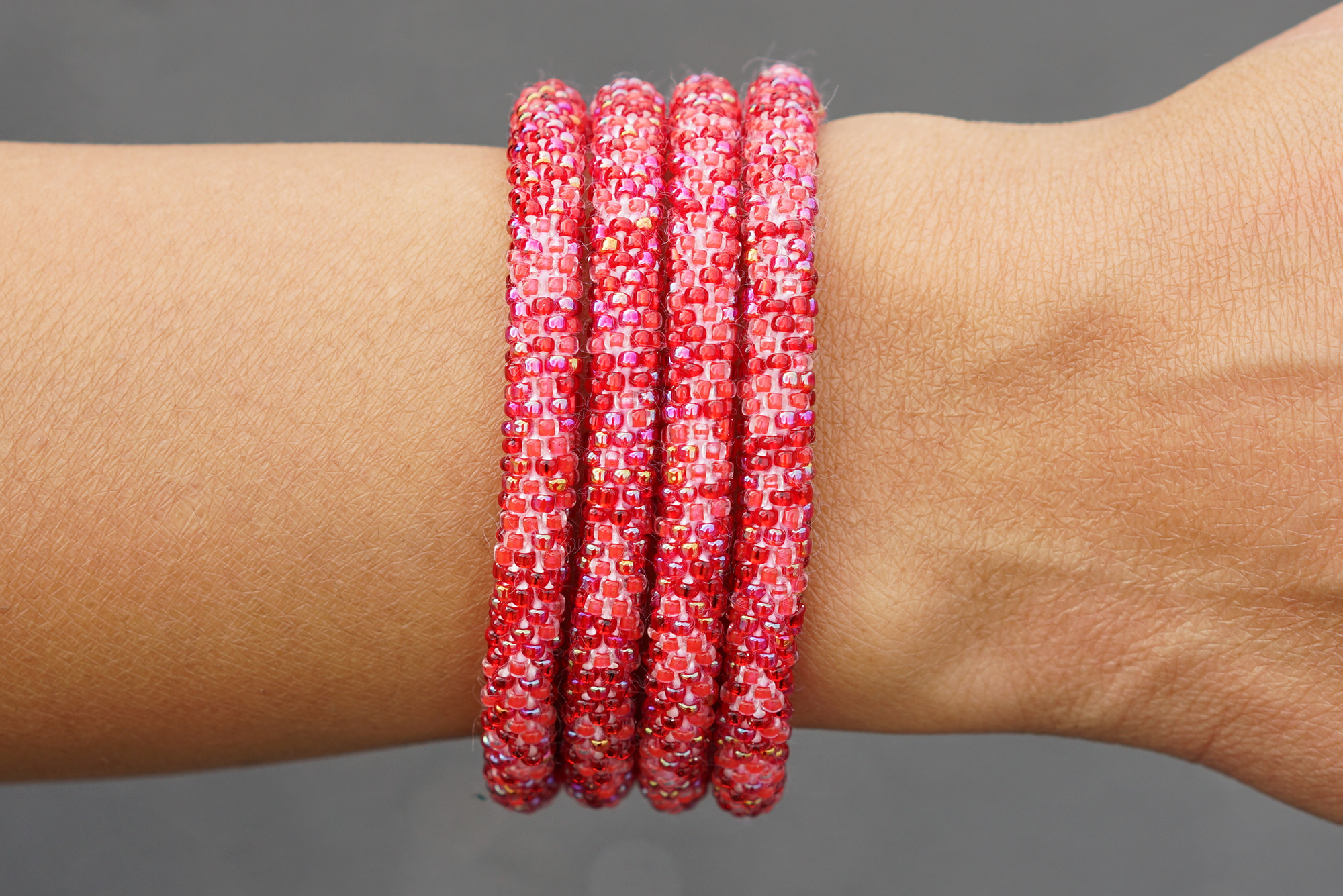 Sashka Co handmade beaded friendship bracelet with mixed shades of red glass beads. Crafted in Nepal by skilled artisans in a confetti pattern.