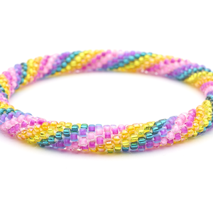 Sashka Co handmade beaded friendship bracelet with pink, matte purple, teal, yellow, and orange glass beads. Crafted in Nepal by skilled artisans in a spiral pattern.
