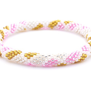 Sashka Co handmade beaded friendship bracelet with pink, white, gold, and clear criss cross spot pattern. Crafted in Nepal by skilled artisans.