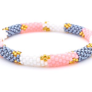 Sashka Co handmade beaded friendship bracelet with pink, white, silver, and gold glass beads. Crafted in Nepal by skilled artisans in a block diamond pattern.