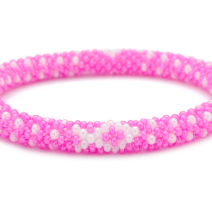 Sashka Co handmade beaded friendship bracelet with pink and white glass beads. Crafted in Nepal by skilled artisans in a detailed ribbon pattern.