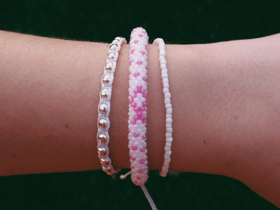 Sashka Co handmade beaded friendship bracelet with pink and white glass beads. Crafted in Nepal by skilled artisans in a detailed ribbon pattern.