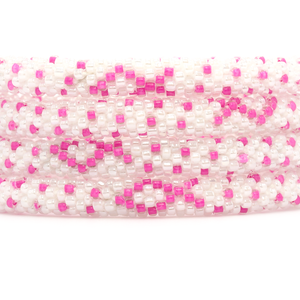 Sashka Co handmade beaded friendship bracelet with pink and white glass beads. Crafted in Nepal by skilled artisans in a detailed ribbon pattern.