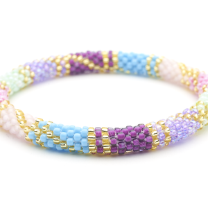 Sashka Co handmade beaded friendship bracelet with purple, blue, mint, pink, and gold glass beads. Crafted in Nepal by skilled artisans in a block spiral pattern.