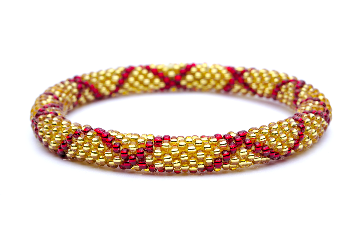 Sashka Co handmade beaded friendship bracelet with red and gold glass beads. Crafted in Nepal by skilled artisans in a criss cross pattern.