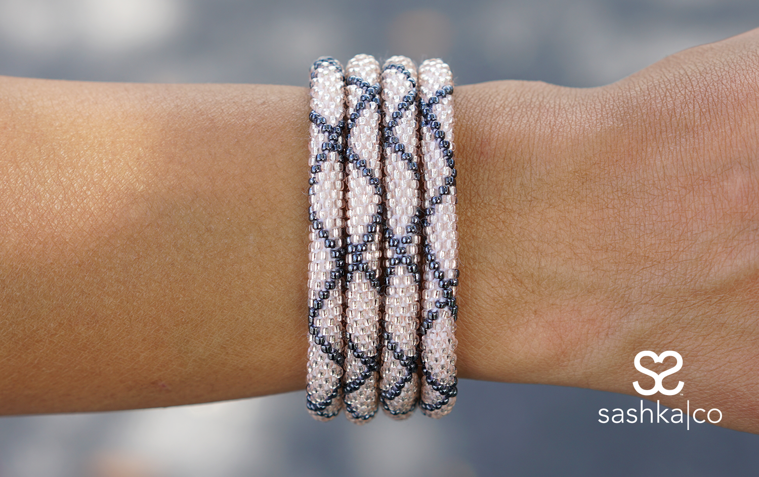 Sashka Co handmade beaded friendship bracelet with rose gold and silver criss cross pattern. Artisan-crafted in Nepal.