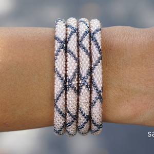 Sashka Co handmade beaded friendship bracelet with rose gold and silver criss cross pattern. Artisan-crafted in Nepal.