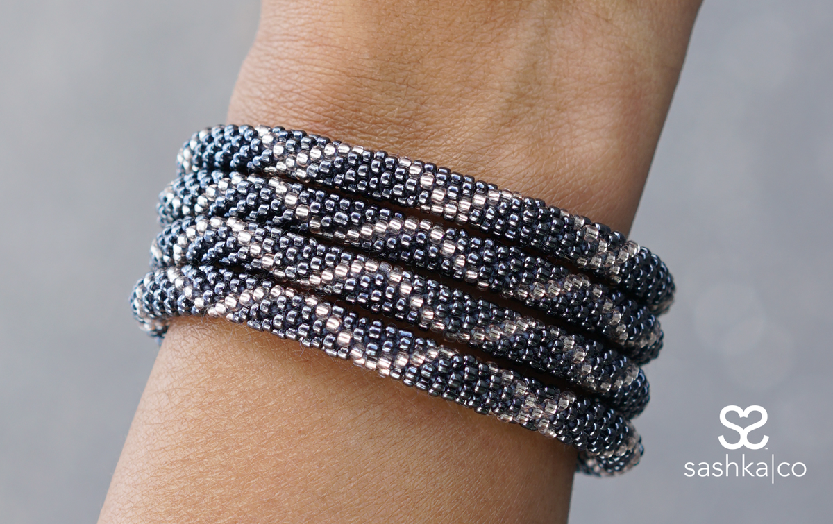 Sashka Co handmade beaded friendship bracelet with silver and clear glass beads. Crafted in Nepal by skilled artisans in a criss cross pattern.