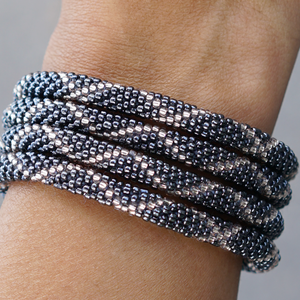 Sashka Co handmade beaded friendship bracelet with silver and clear glass beads. Crafted in Nepal by skilled artisans in a criss cross pattern.