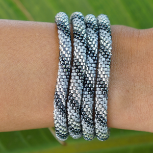 Sashka Co handmade beaded friendship bracelet with silver, gray, and clear glass beads. Crafted in Nepal by skilled artisans in a spiral pattern.