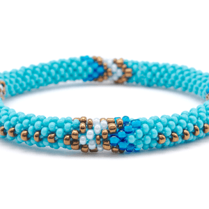 Sashka Co handmade beaded friendship bracelet with turquoise, bronze, white, and blue glass beads. Crafted in Nepal by skilled artisans in an arrow pattern.

