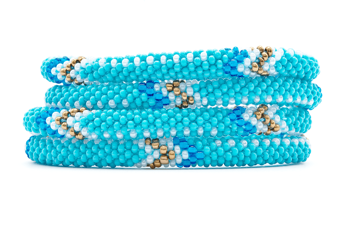 Sashka Co handmade beaded friendship bracelet with turquoise, white, bronze, and blue glass beads. Crafted in Nepal by skilled artisans in an arrow pattern.