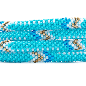 Sashka Co handmade beaded friendship bracelet with turquoise, white, bronze, and blue glass beads. Crafted in Nepal by skilled artisans in an arrow pattern.