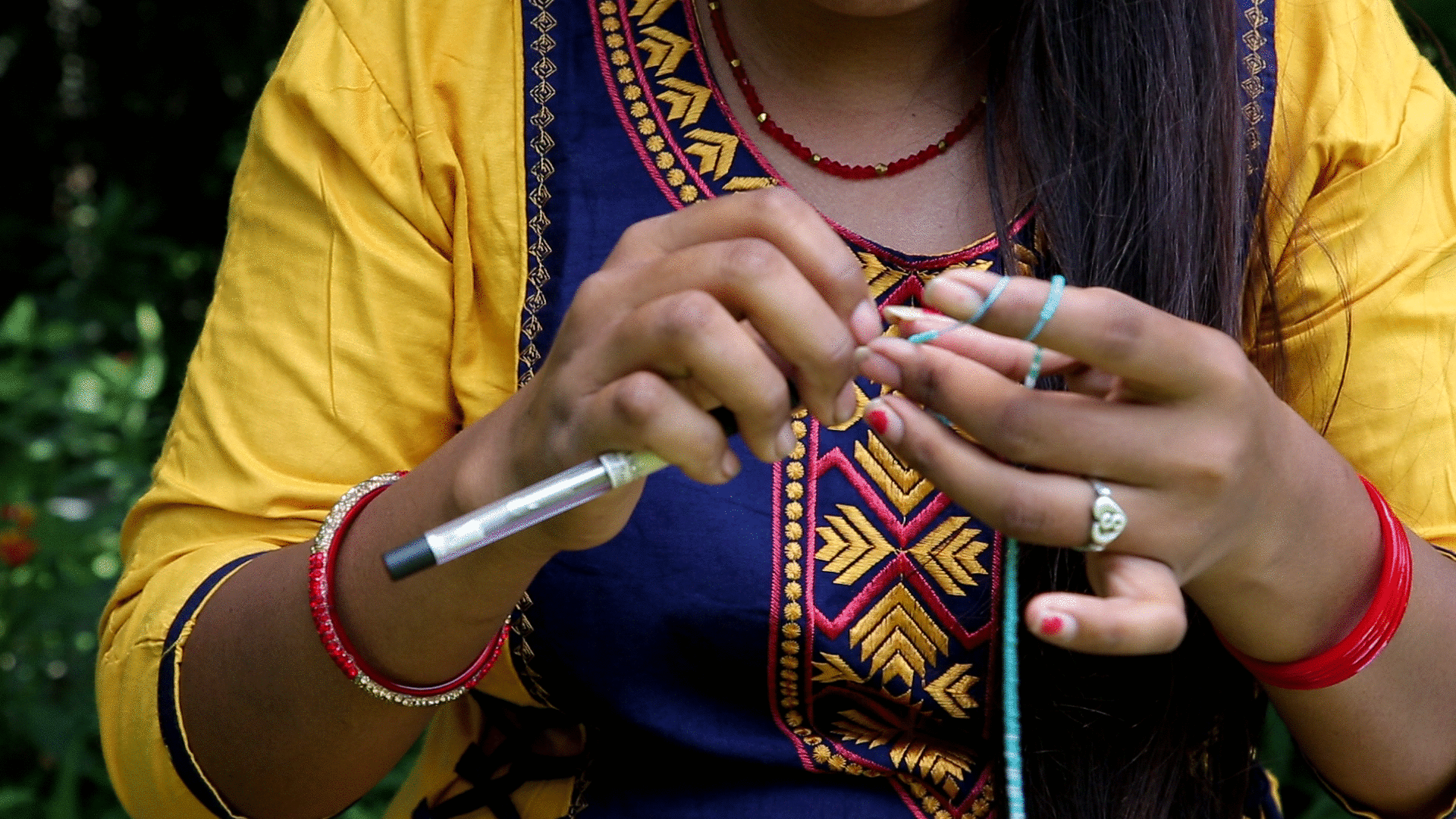 Sashka Co handmade beaded friendship bracelet with turquoise, white, bronze, and blue glass beads. Crafted in Nepal by skilled artisans in an arrow pattern.