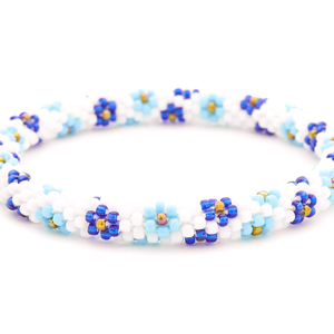 Sashka Co handmade beaded friendship bracelet with white, baby blue, blue, and iridescent flower pattern. Crafted in Nepal.
