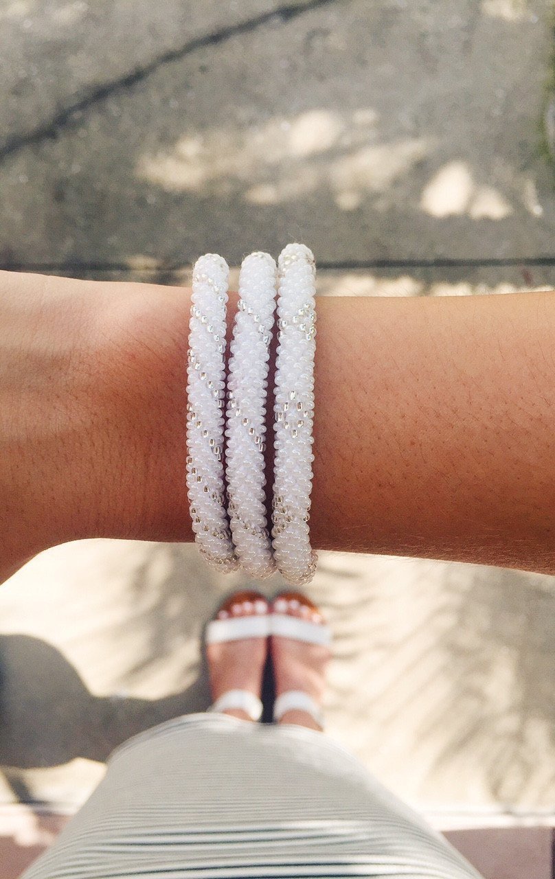 Sashka Co handmade beaded friendship bracelet with white and clear glass beads. Crafted in Nepal by skilled artisans in a spiral pattern.

