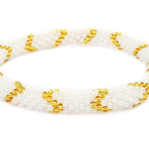 Sashka Co handmade beaded friendship bracelet with white and gold glass beads. Crafted in Nepal by skilled artisans in a chevron pattern.

