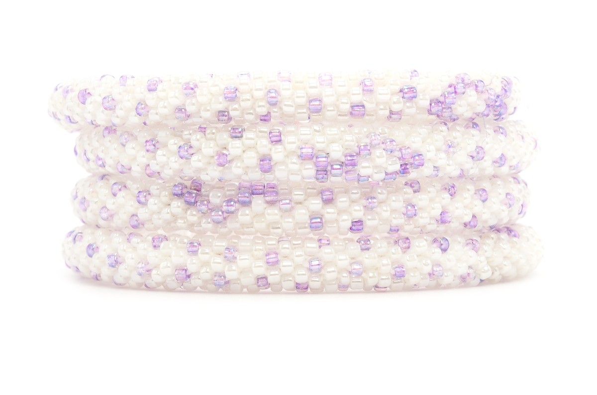 Sashka Co handmade beaded friendship bracelet with white and light purple glass beads. Crafted in Nepal by skilled artisans in a cancer ribbon pattern.