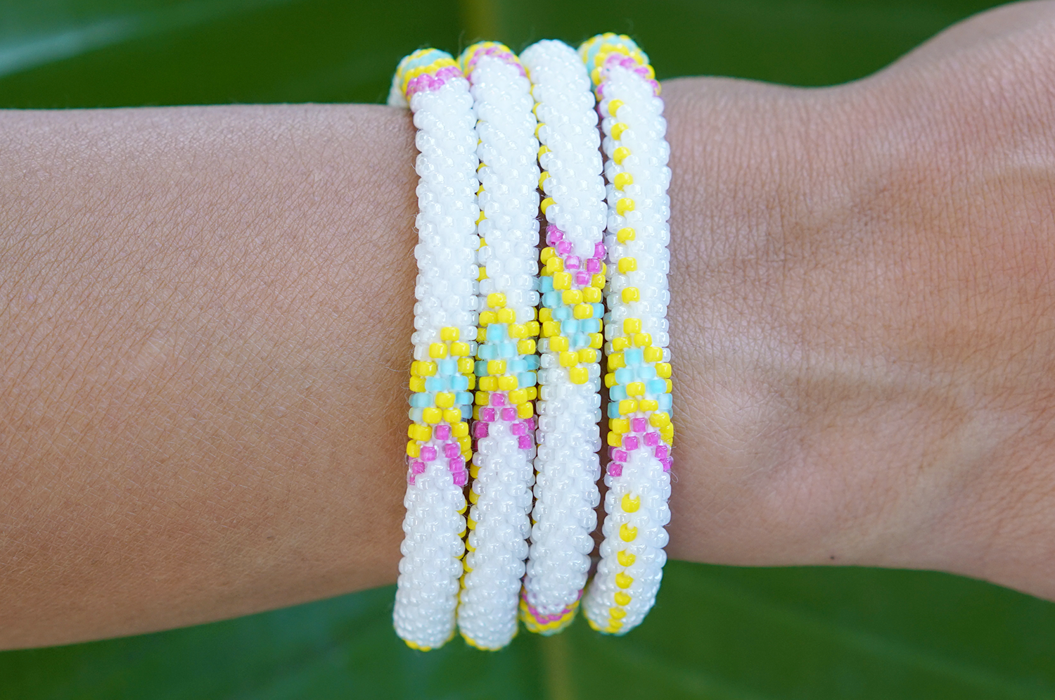 Sashka Co handmade beaded friendship bracelet with white, yellow, pink, and blue glass beads. Crafted in Nepal by skilled artisans.