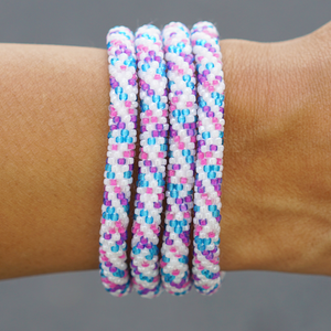 Sashka Co handmade beaded friendship bracelet with white, blue, pink, and purple glass beads. Crafted in Nepal by skilled artisans in a spiral confetti pattern.