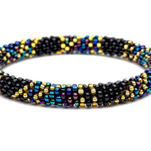 Handmade glass bead Black, Gold, Iridescent bracelet from Nepal, featuring a roll design. Also known as a beaded bracelet, seed bead bracelet, beach glass bracelet, or sea glass bracelet.
