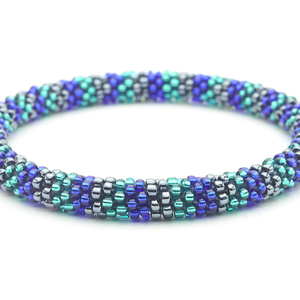 Sashka Co handmade beaded friendship bracelet with blue, teal, and silver glass beads. Crafted in Nepal by skilled artisans in a line pattern.