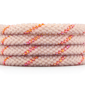 Sashka Co. handmade glass beaded friendship bracelet with mauve and iridescent red glass beads in a spiral pattern. Crafted in Nepal by skilled artisans.