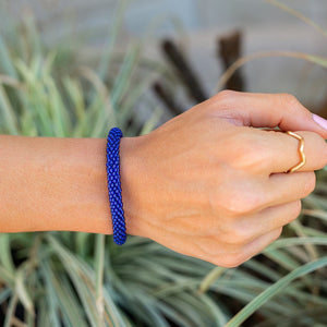 Handmade glass bead deep blue bracelet from Nepal, featuring a roll design. Also known as a beaded bracelet, seed bead bracelet, beach glass bracelet, or sea glass bracelet