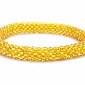 Handmade glass bead gold bracelet from Nepal, featuring a roll design. Also known as a beaded bracelet, seed bead bracelet, beach glass bracelet, or sea glass bracelet