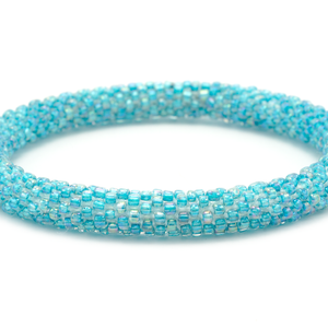 Handmade glass bead iridescent aqua bracelet from Nepal, featuring a roll design. Also known as a beaded bracelet, seed bead bracelet, beach glass bracelet, or sea glass bracelet