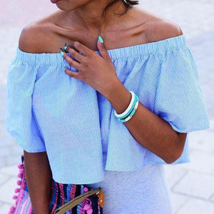3 Sashka Co. bracelets on a wrist featuring white and turquoise colors. Handmade glass bead bracelet from Nepal, featuring a roll design. Also known as a beaded bracelet, seed bead bracelet, beach glass bracelet, or sea glass bracelet